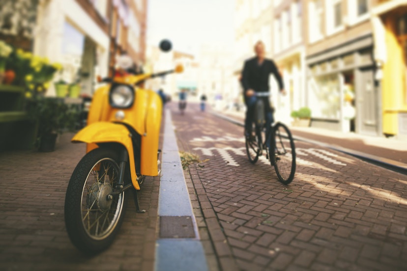 Street scene from Amsterdam downtown. Yellow scooter. Tilt shift lens.