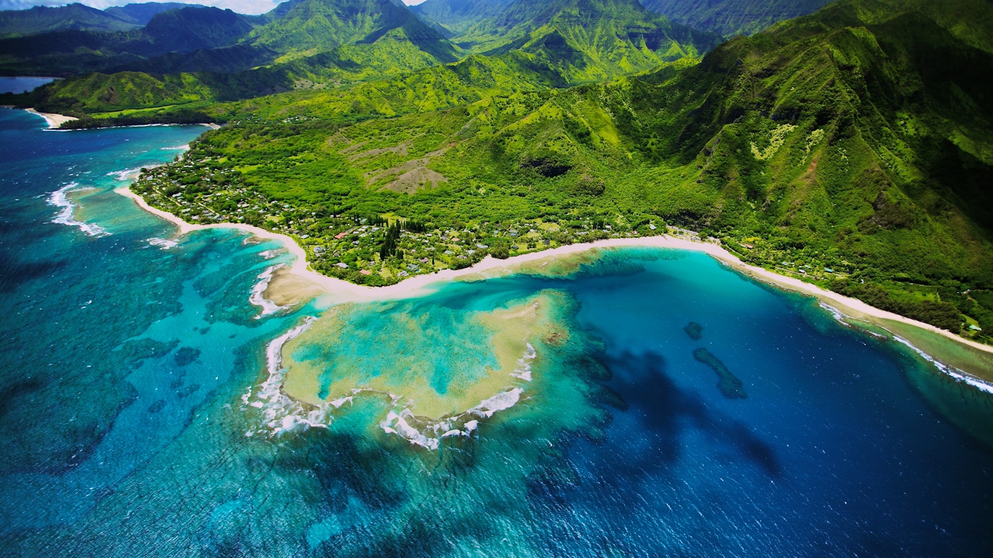 An aerial photo of Tunnels beach. Tunnels is located on Kauai's North Shore and is named after the tunnels that snorkelers and divers can observe when navigating the reef.
