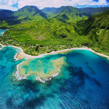 An aerial photo of Tunnels beach. Tunnels is located on Kauai's North Shore and is named after the tunnels that snorkelers and divers can observe when navigating the reef.