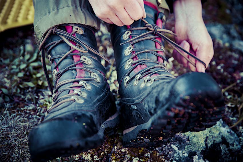 Be sure to wear the proper gear when hiking the Hudson Valley trails Low view of a hiker tying the laces of their hiking boots