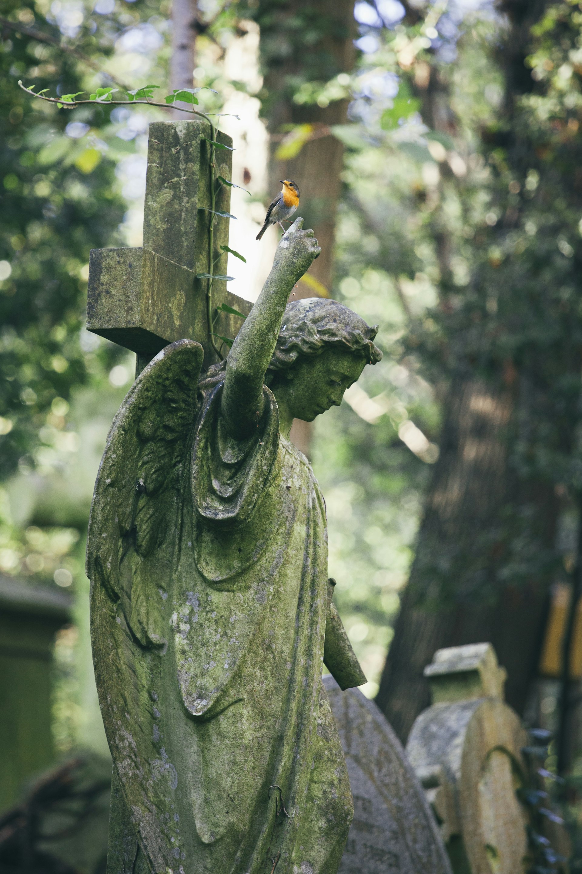 Statue of woman with red robin perched on an outstretched finger, Highgate Cemetery, London, England, United Kingdom, Europe