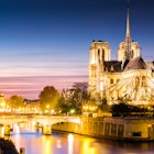Notre Dame cathedral lit up at dusk.