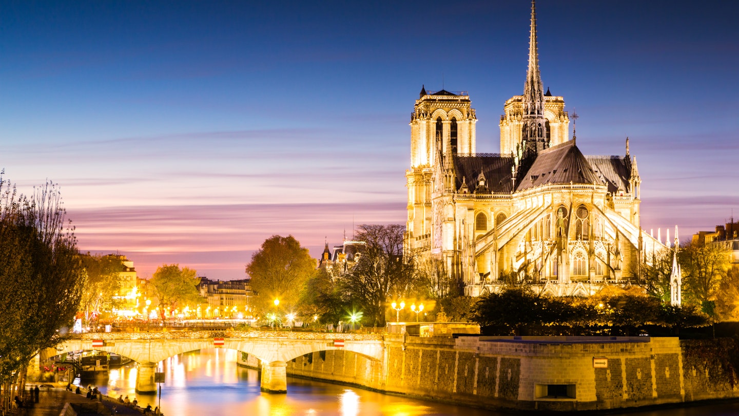 Notre Dame cathedral lit up at dusk.