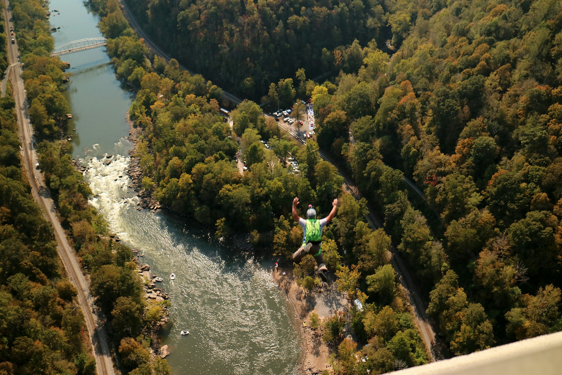 A person BASE jumping from the New River Gorge Bridge on Bridge Day in Fayetteville, West Virginia