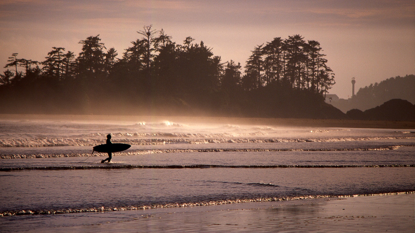 Silhouette Surfer Walking On Calm Beach