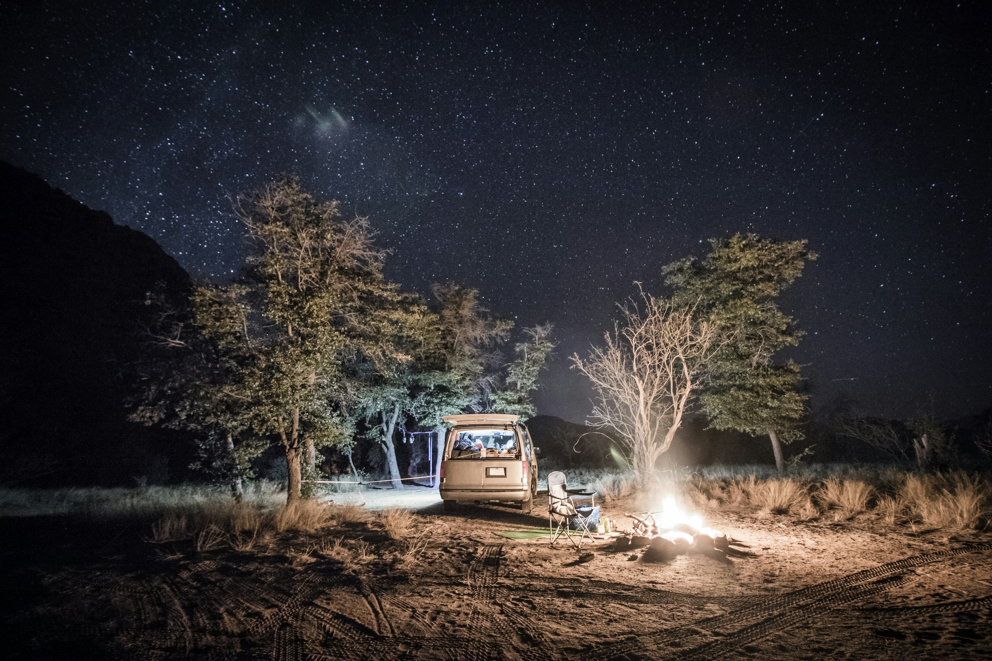 A campervan and fire under the stars at Cochise Stronghold camp in Arizona.