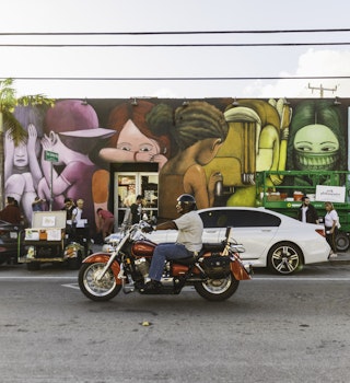 Traffic passes colourful street art in Miami's Wynwood District.