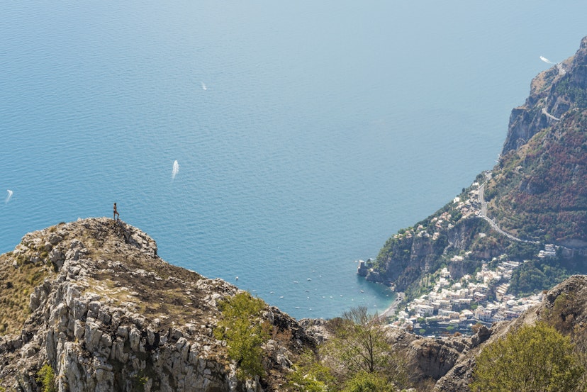 A hiker looking at the Amalfi Coast and the town of Positano.
