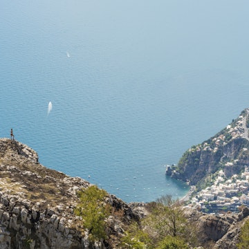 A hiker looking at the Amalfi Coast and the town of Positano.