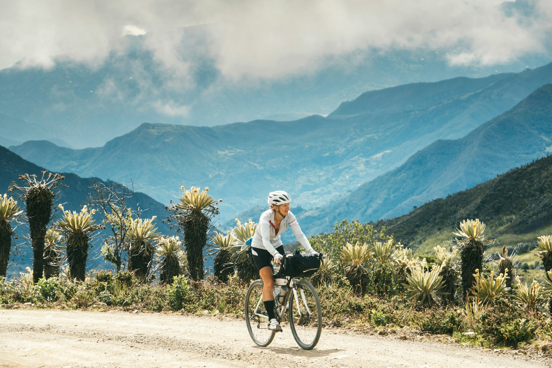 A female cyclist rides through the Paramo in the Andes Mountains of Boyacá, Colombia, South America