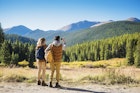 Hispanic couple photographing mountains, Breckenridge, Colorado, United States,