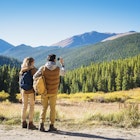 Hispanic couple photographing mountains, Breckenridge, Colorado, United States,