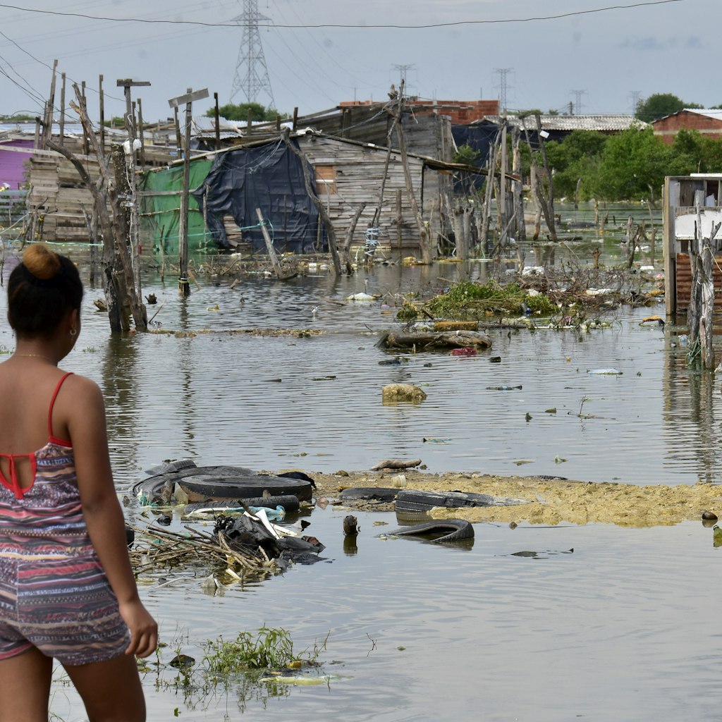 CARTAGENA, COLOMBIA - NOVEMBER 17: A woman resident of the Nuevo Paraiso neighborhood on the island of Belen looks at the flooded site where houses existed after the passage of Hurrican Iota on November 17, 2020 in Cartagena, Colombia. Hurricane Iota hit Colombia's Caribbean coast and Islands of San Andrés and Providencia as category five storm on Monday, producing floods and damages. Since records are kept, Iota is the strongest storm to hit the country. (Photo by Javier Garcia Salcedo/Vizzor Image/Getty Images)