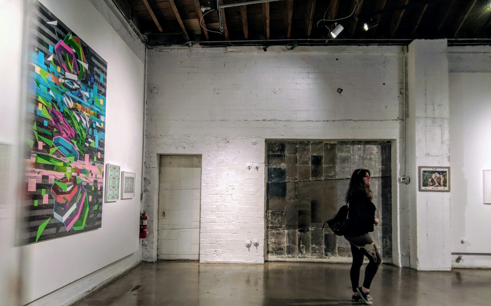 A woman walks through an art gallery