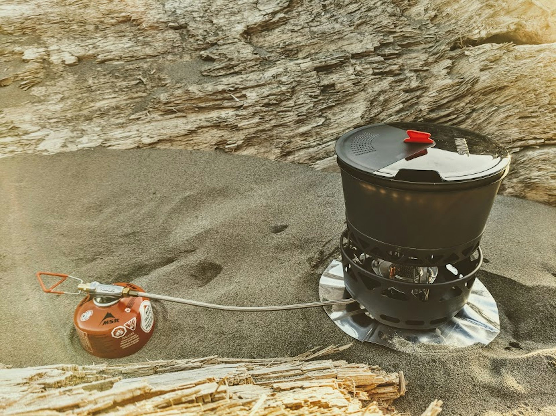 A Primus PrimeTech pot set sits on a Primus stove in the sand at Second Beach in Washington state