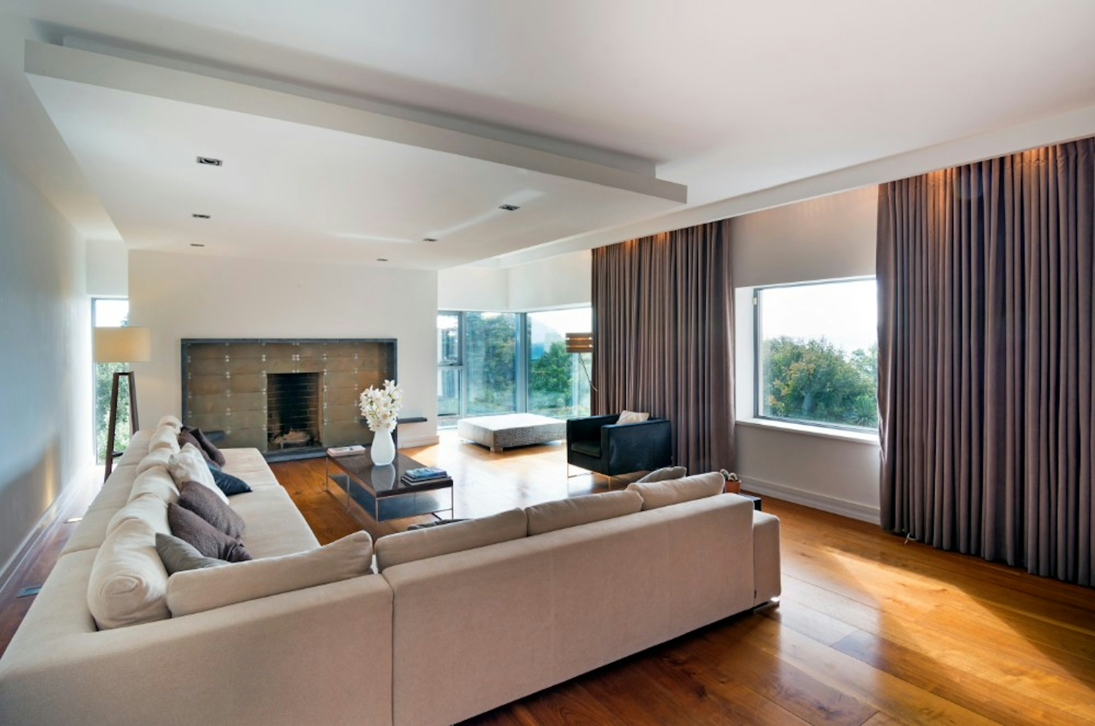 A large living room with grey sofas