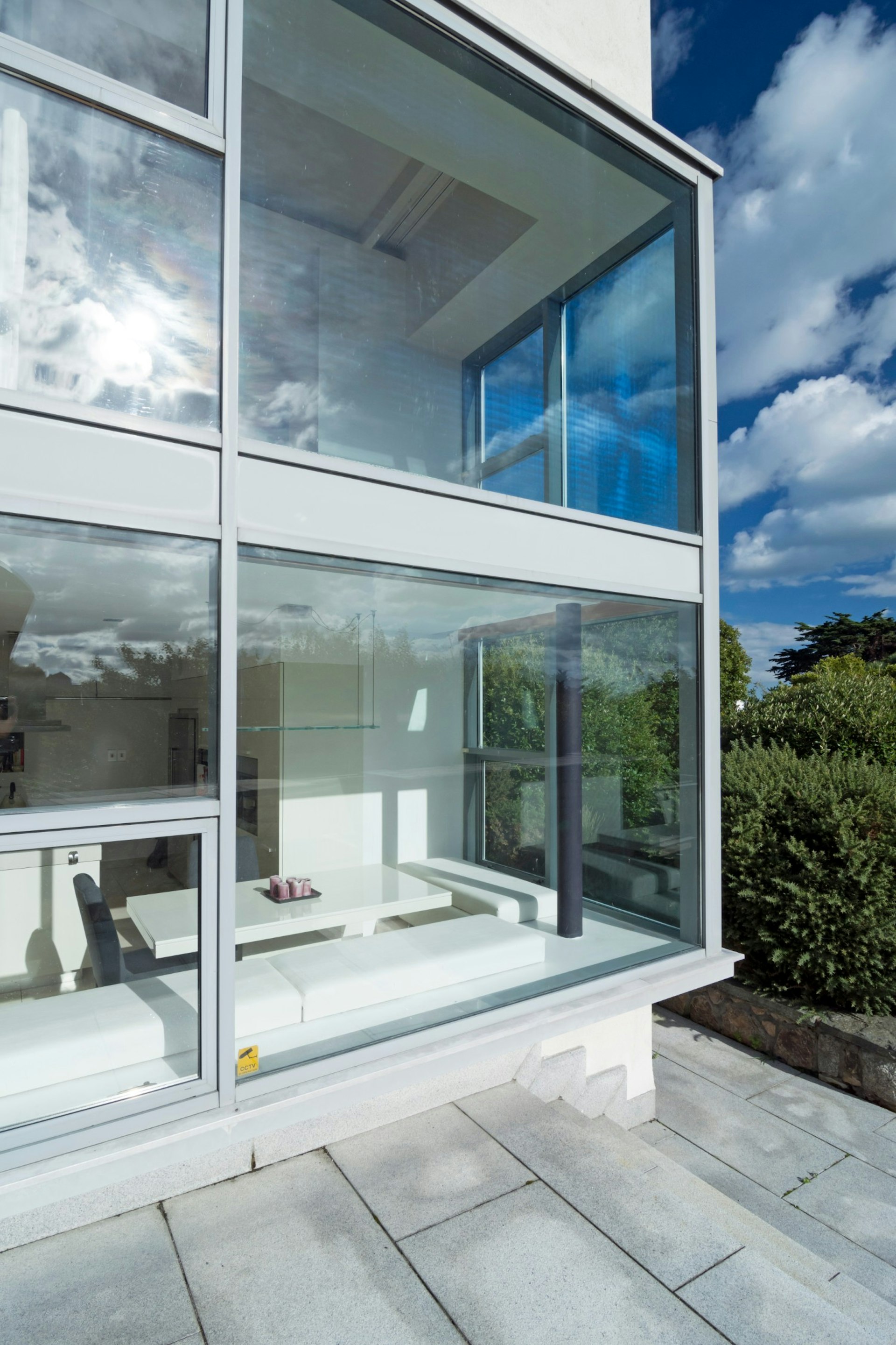 The exterior of a kitchen with a table set into the window