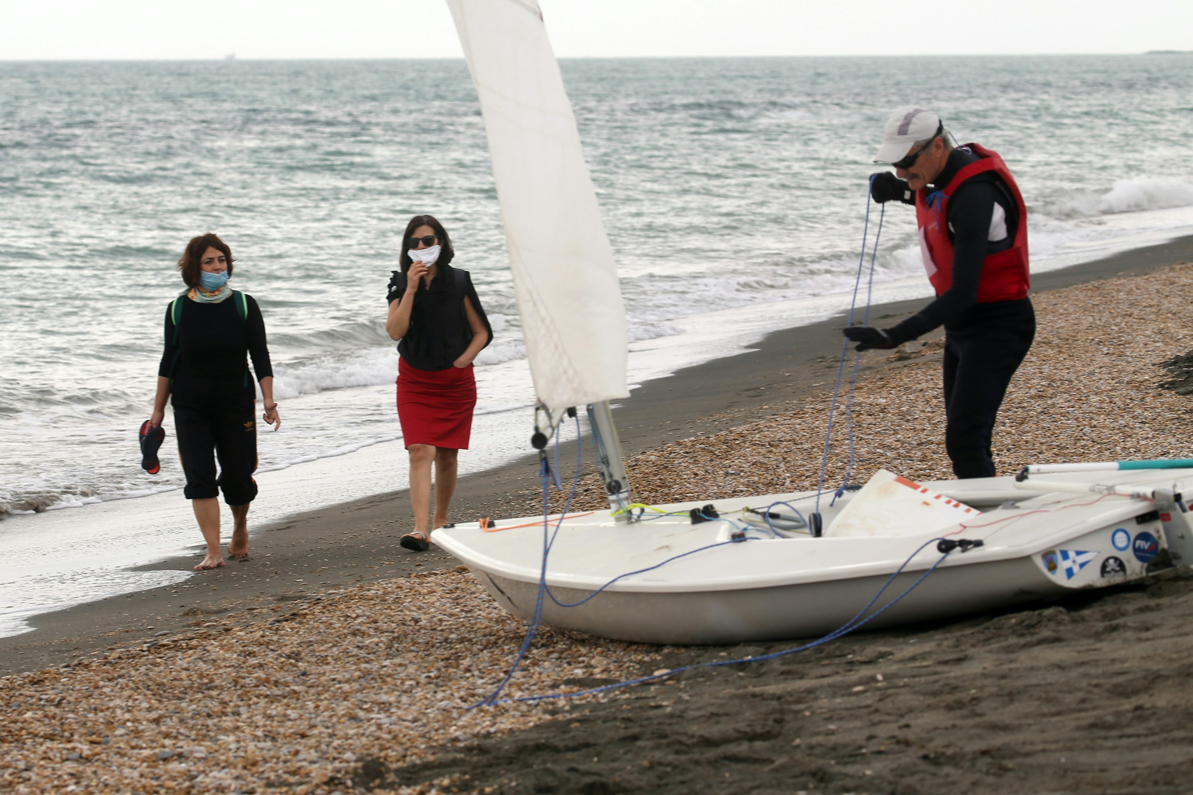 Women walking on Ostia beach in Italy