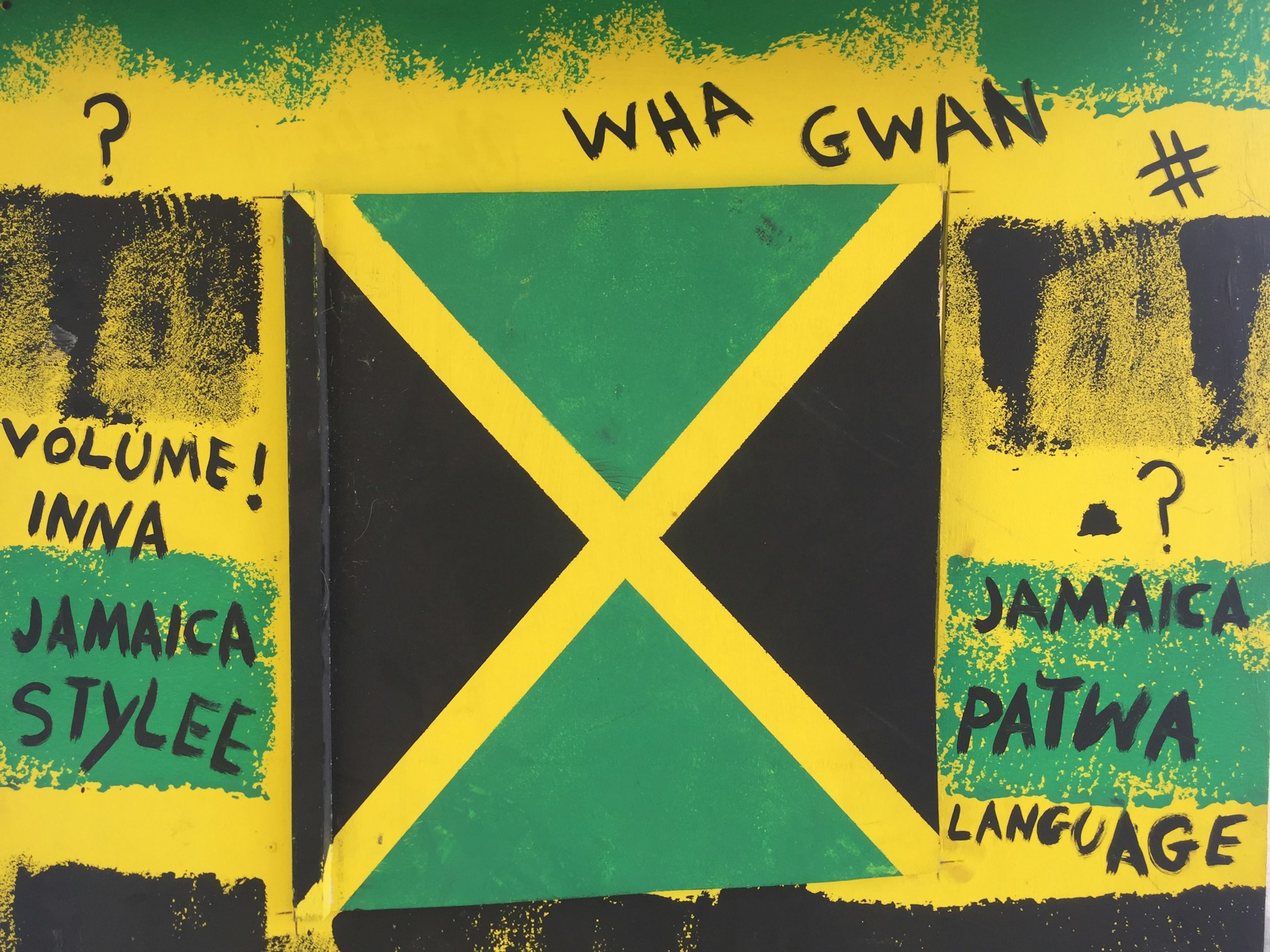 Graffiti written around a depiction of the Jamaican flag