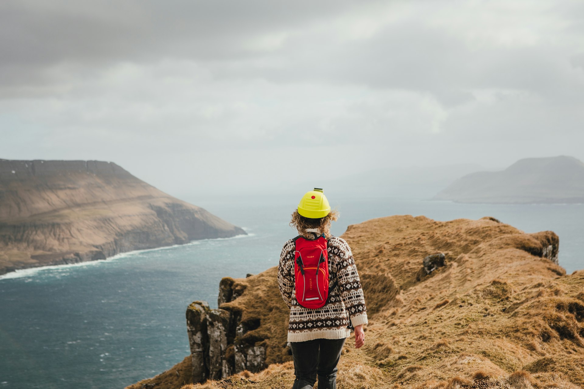 A woman explore the countyside of the Faroe Islands. 