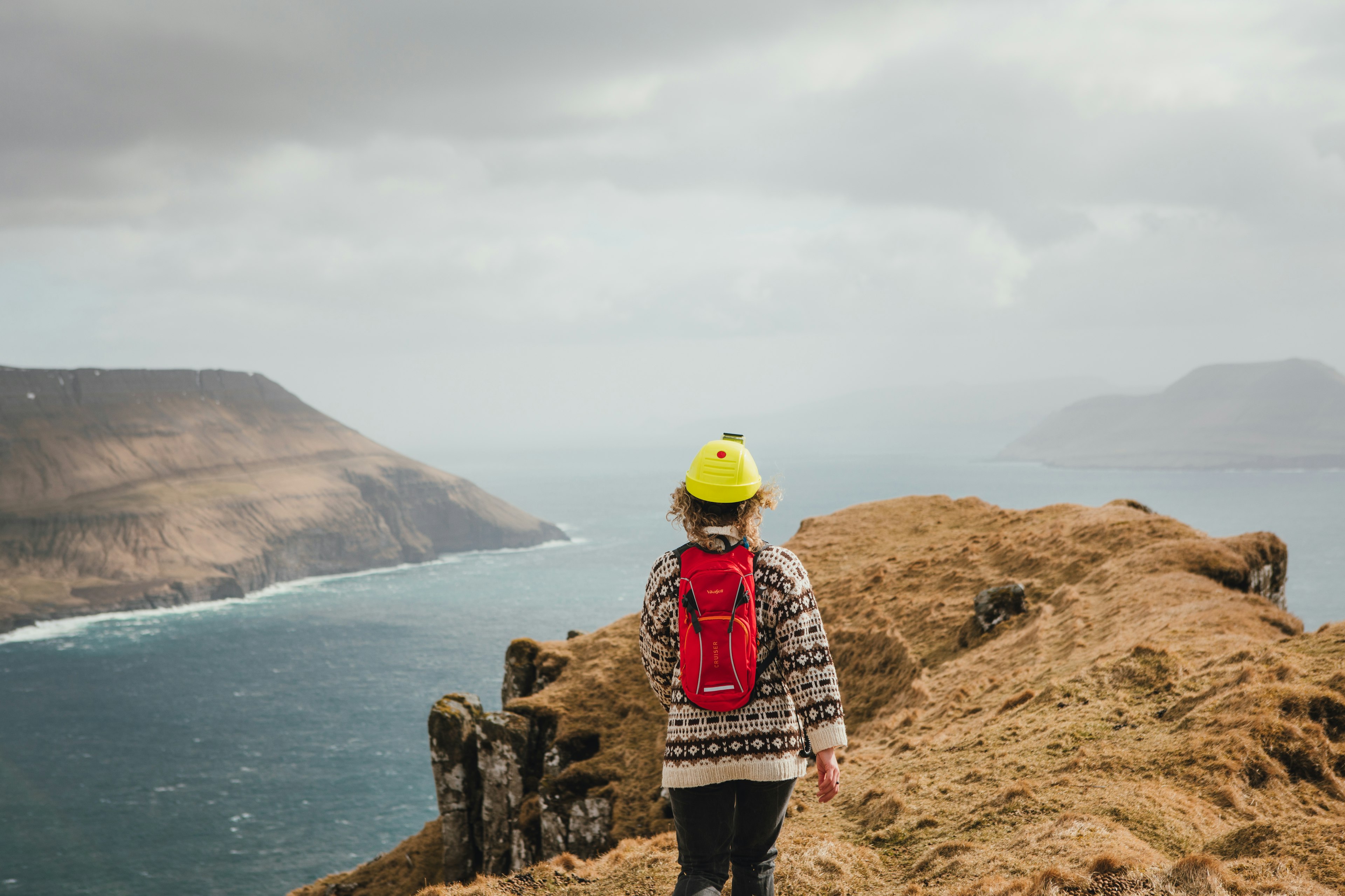 A woman explore the countyside of the Faroe Islands.