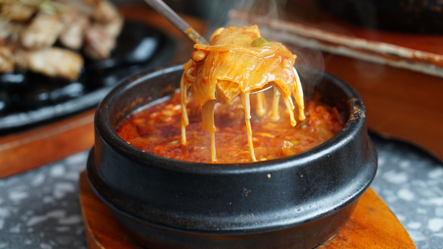 Kimchi Soup with tofu and pork belly served in clay pot, One of the most loved of all the stews in Korean cuisine, Most popular food in Korea.