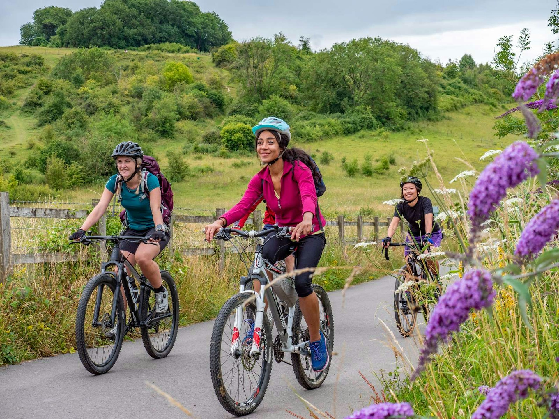 Three women ride into Winchester along the Itchen Way cycle path, past St Catherine's Hill nature reserve