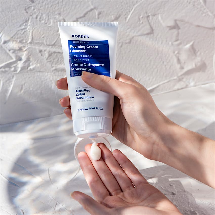 Korres Greek Yoghurt Foaming Cream Cleanser.jpg A hand squeezing out Korres's Greek Yoghurt Foaming Cream Cleanser