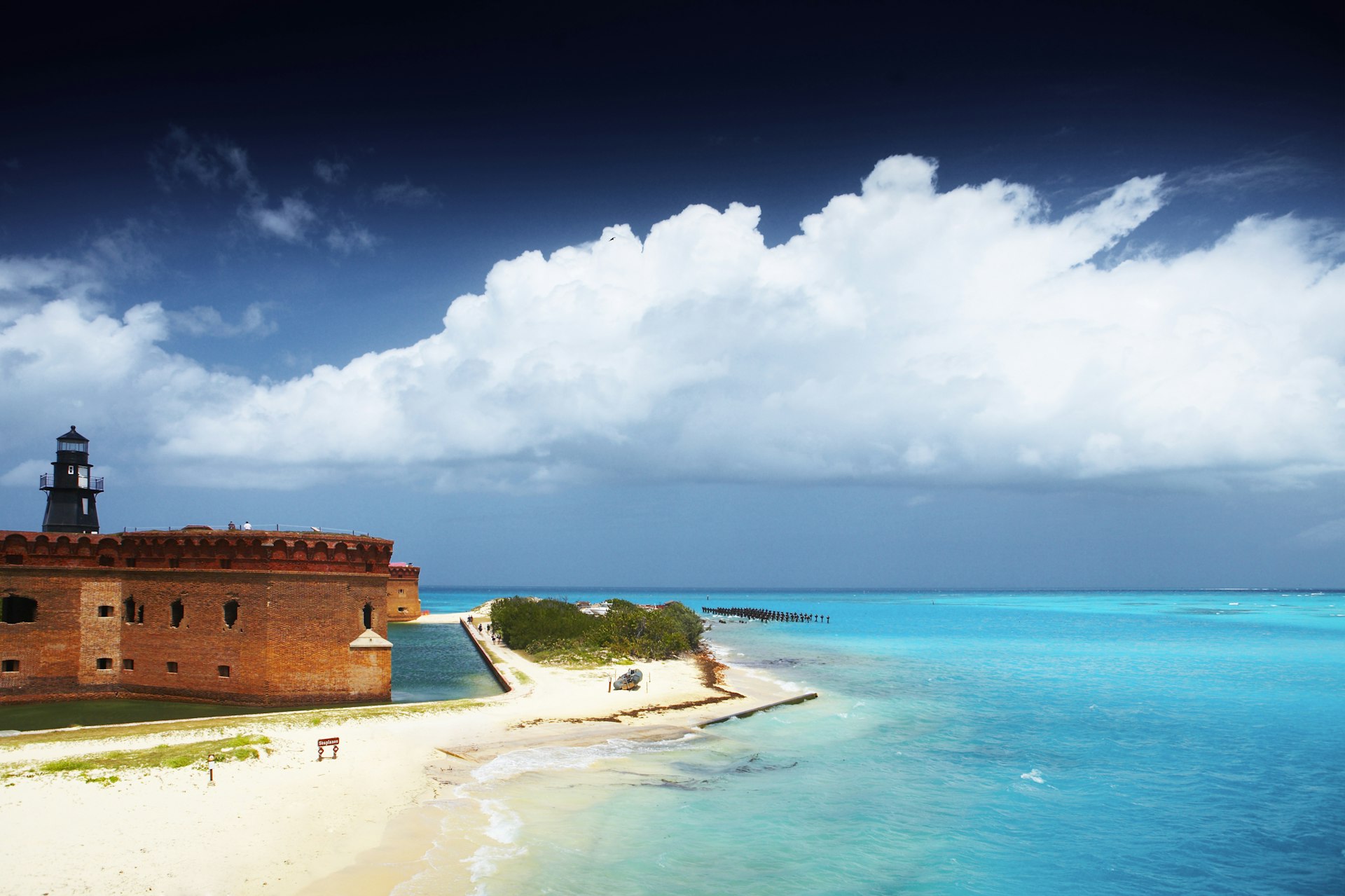 An old fort on a tropical beach, with blue skies and waters