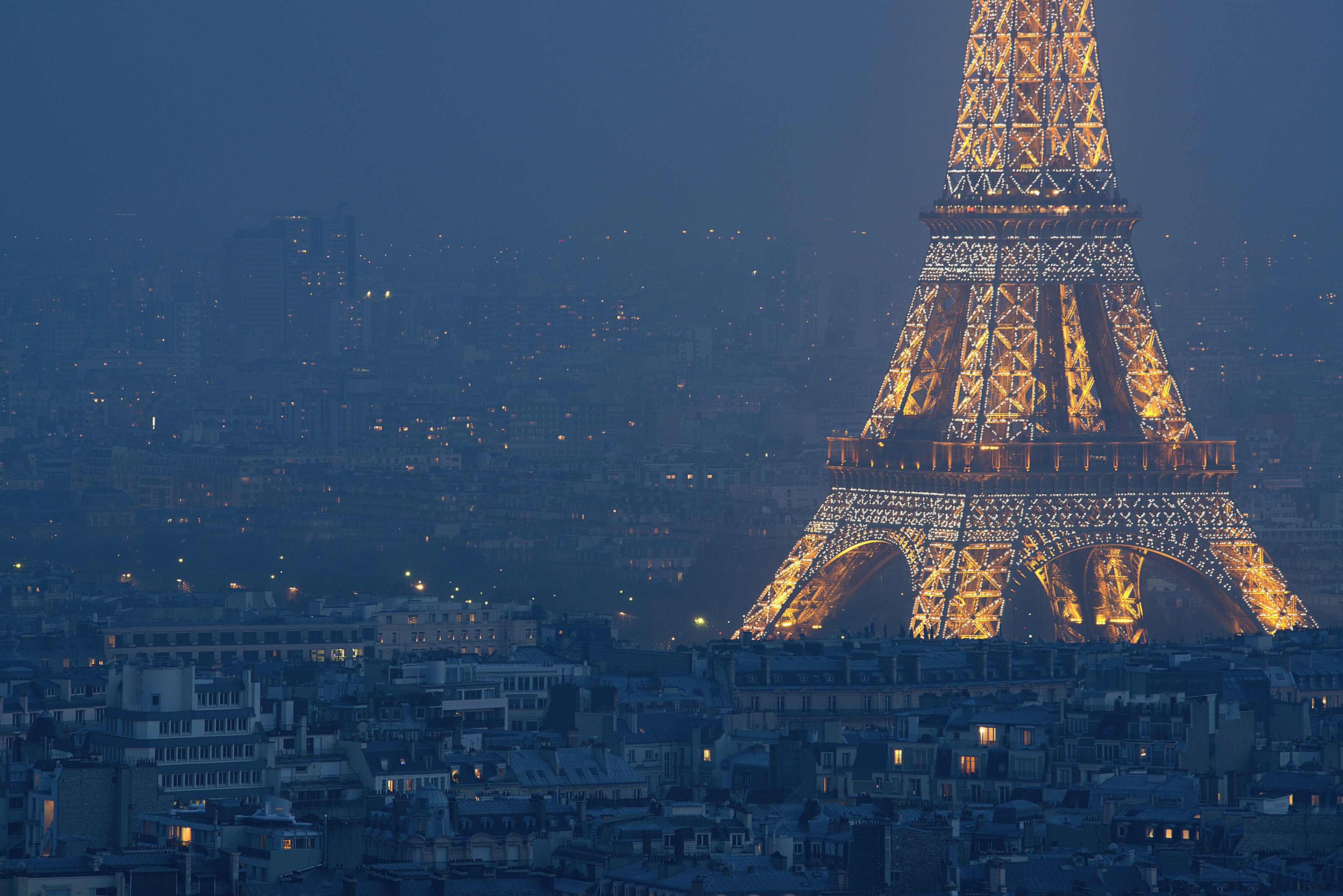 Eiffel Tower illuminated at night.