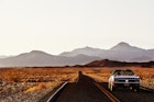 Ford Mustang on desert highway.