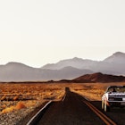 Ford Mustang on desert highway.