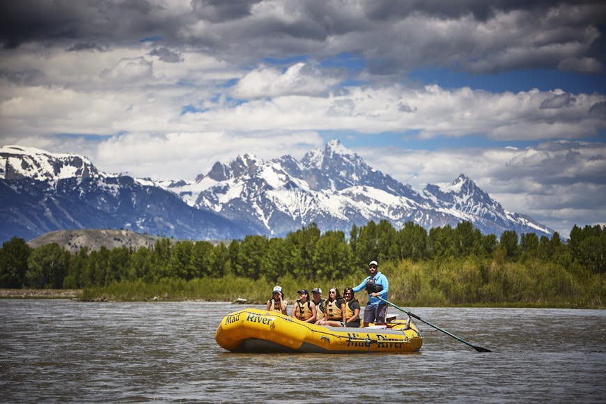 A raft of paddlers on the Snake River in front of the Grand Teton Mountains