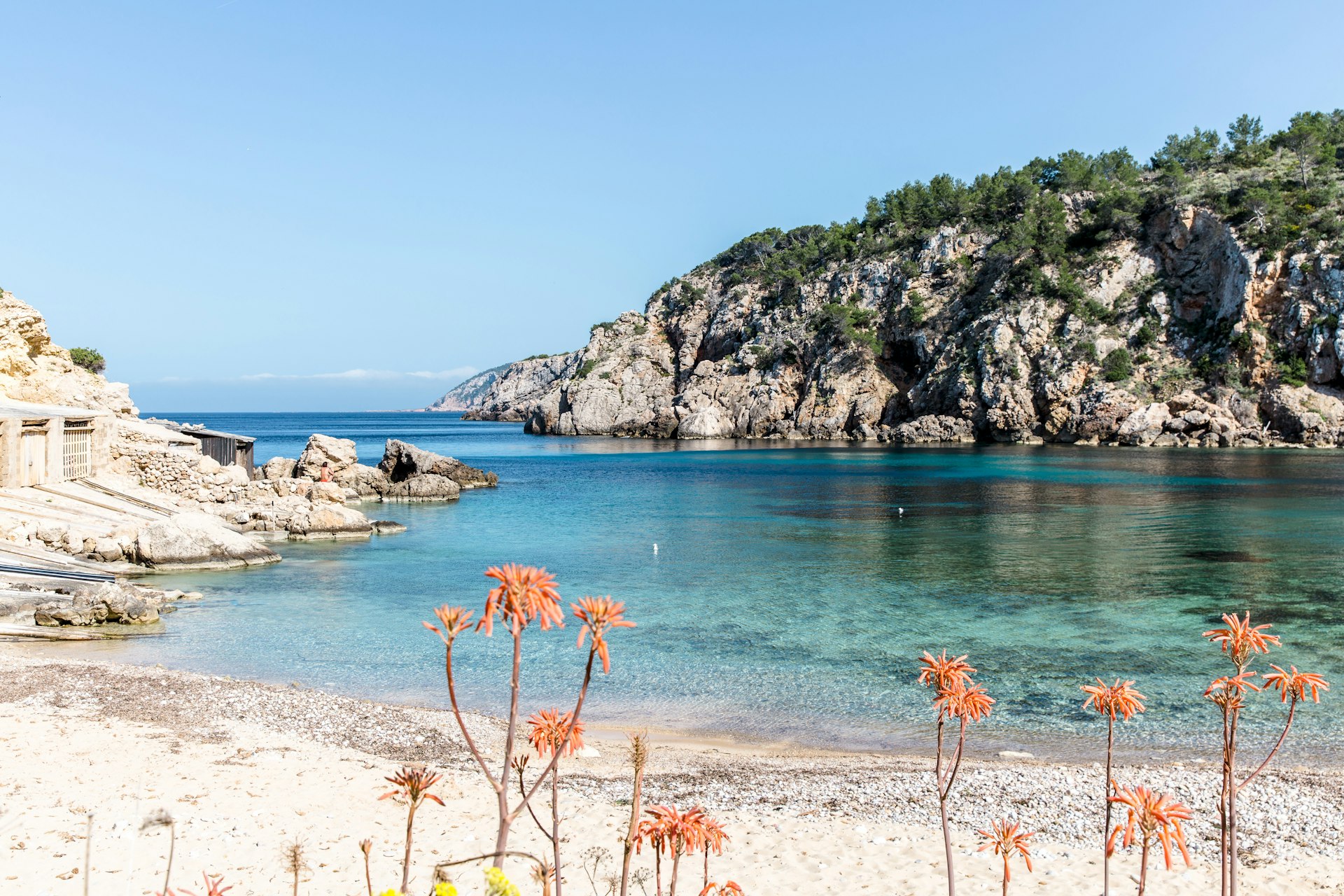 A woman sits on a rock in the secluded Cala d’en Serra beach on Ibiza’s northern shore