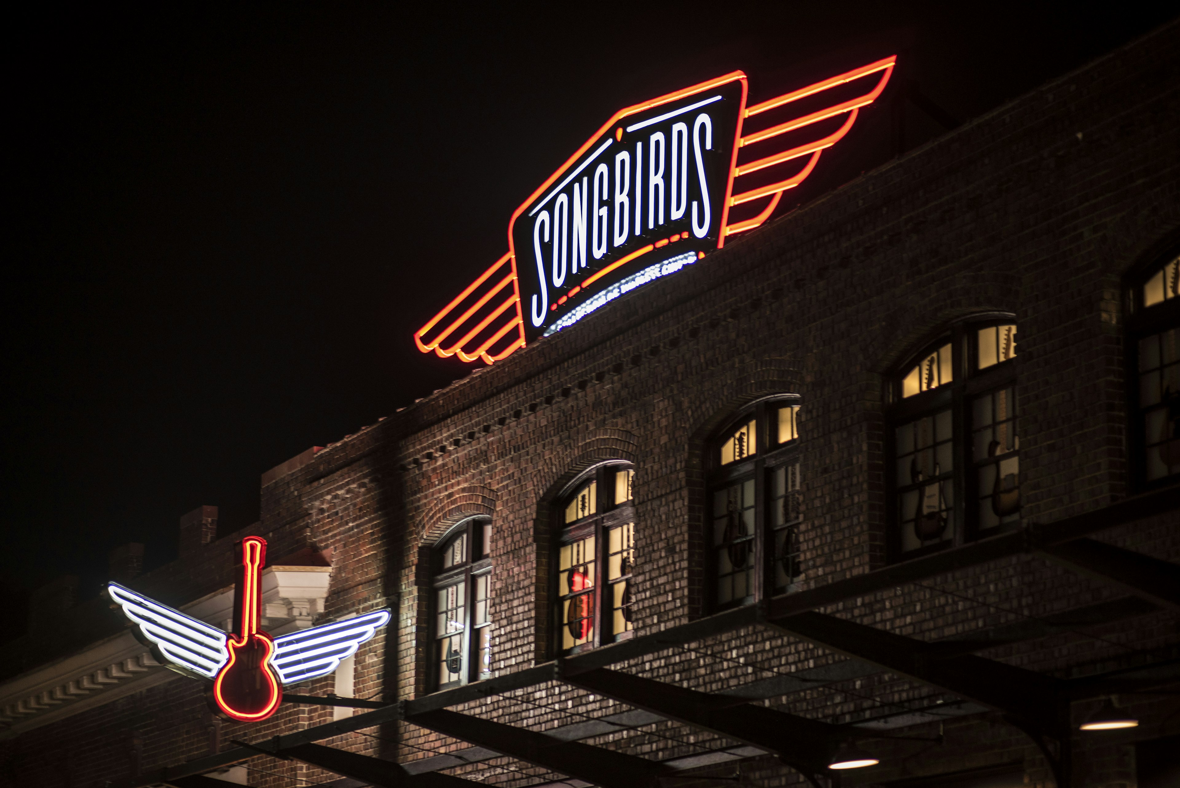 The neon lit exterior of the Songbirds Guitar Museum in Chattanooga TN