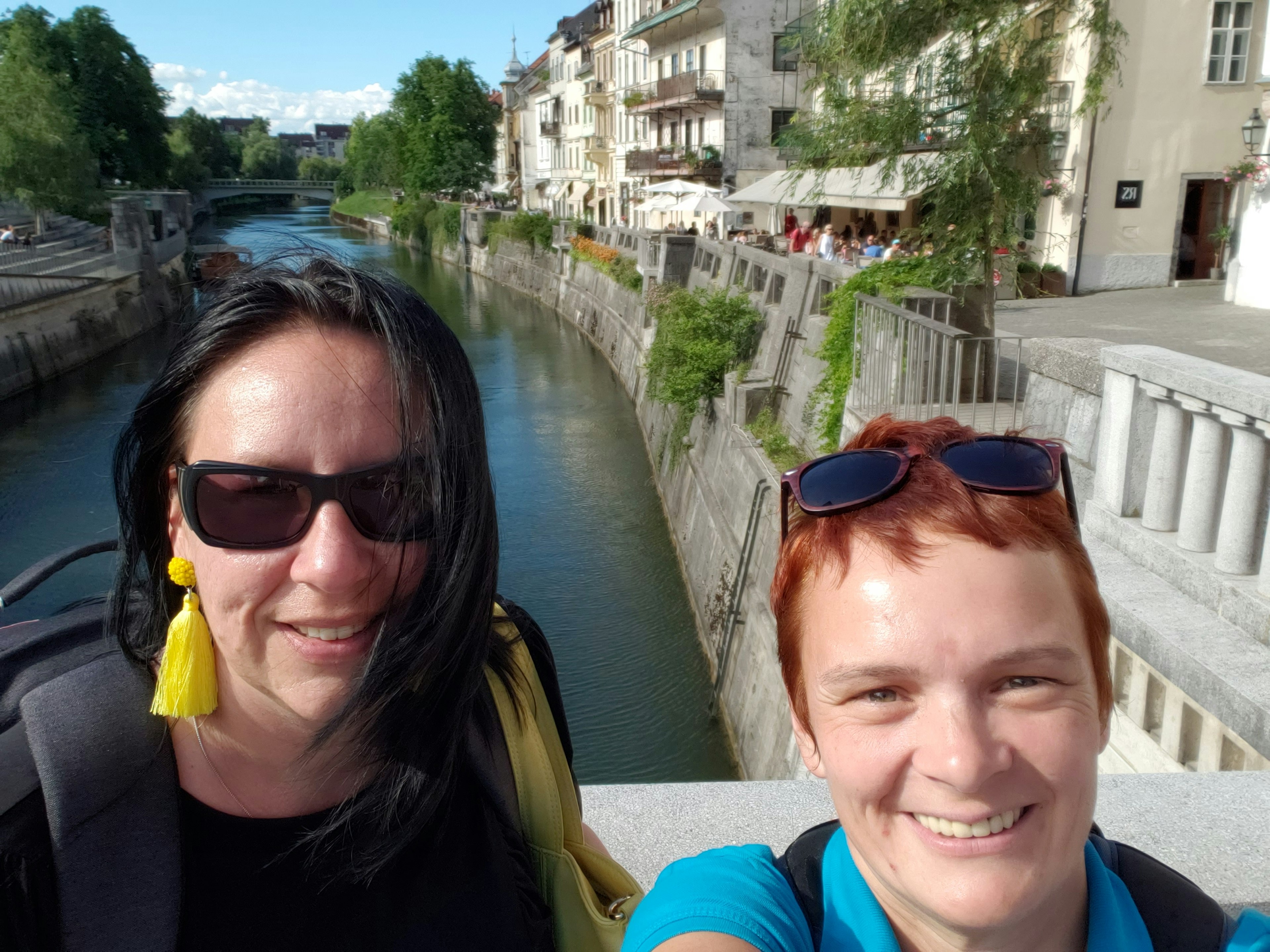 Two women take a selfie on a town bridge