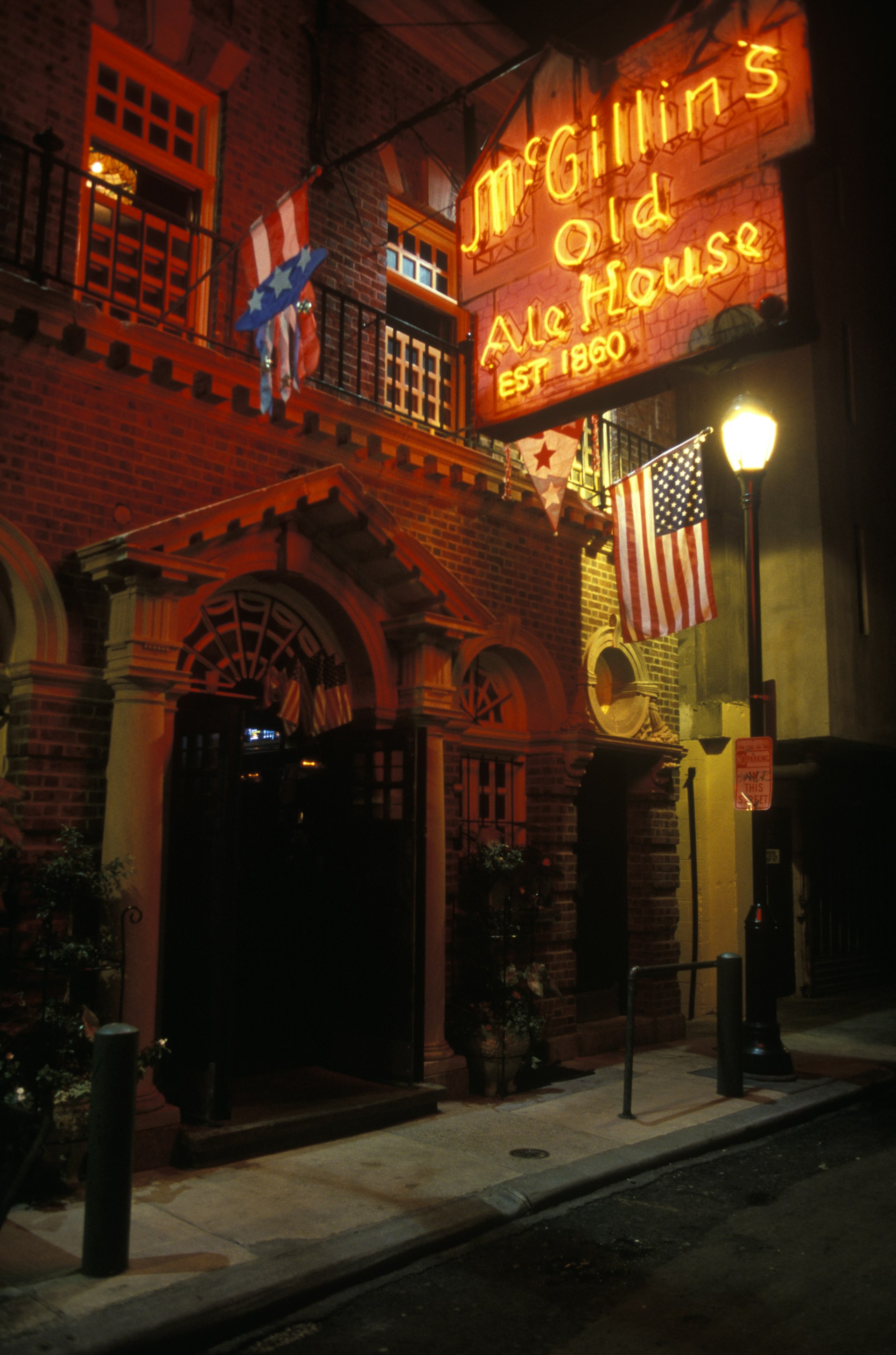 A neon sign that says 'McGillin's Old Ale House est 1860' hangs above the establishment 