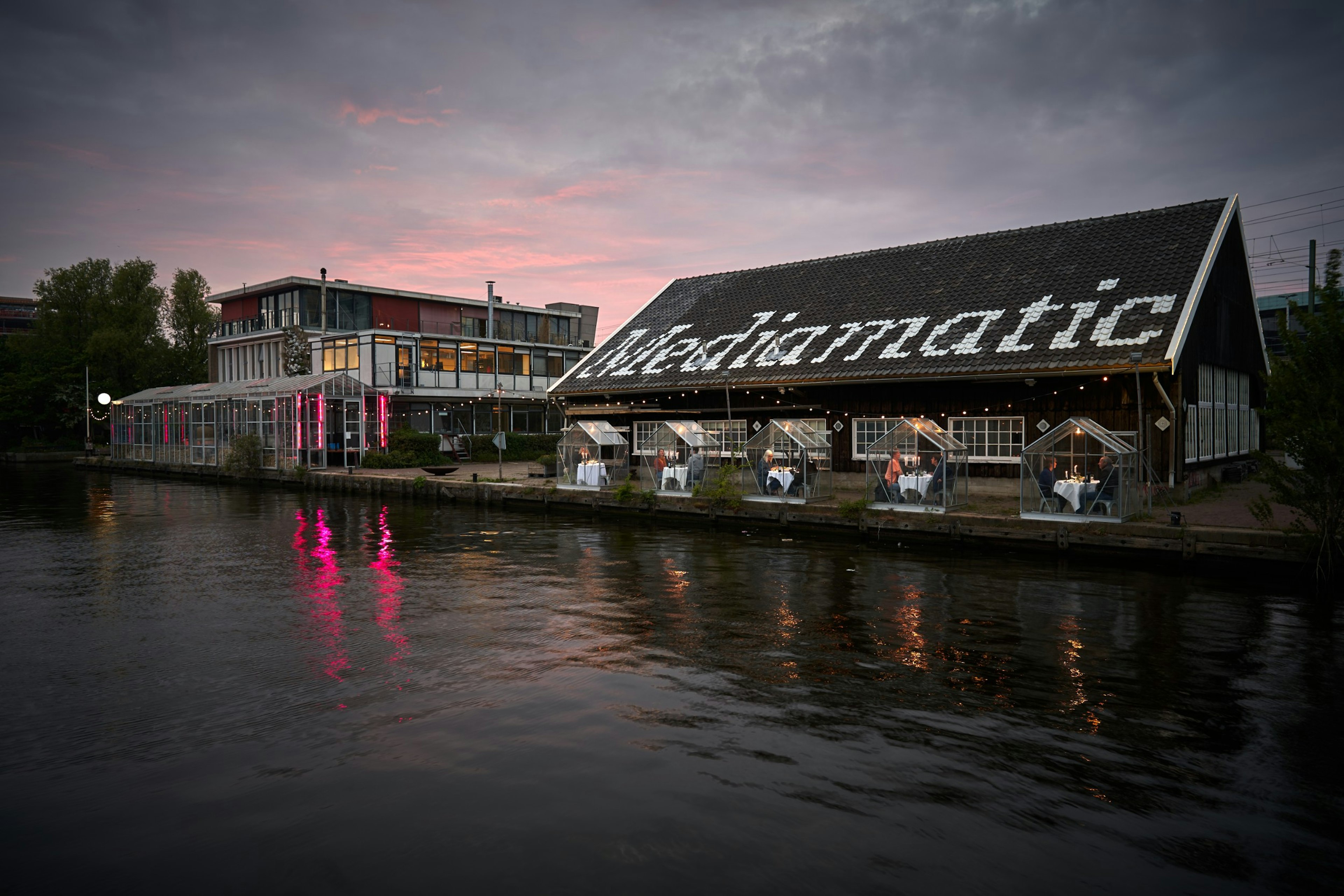 A waterfront vegan restaurant with glass cubicles