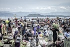 Vendors and shoppers at Kituku market on the shores of Lake Kivu in Goma, eastern Democratic Republic of Congo, April 2, 2020. Many Congolese survive on their daily earnings and cannot afford to follow health advisories on maintaining social distance.