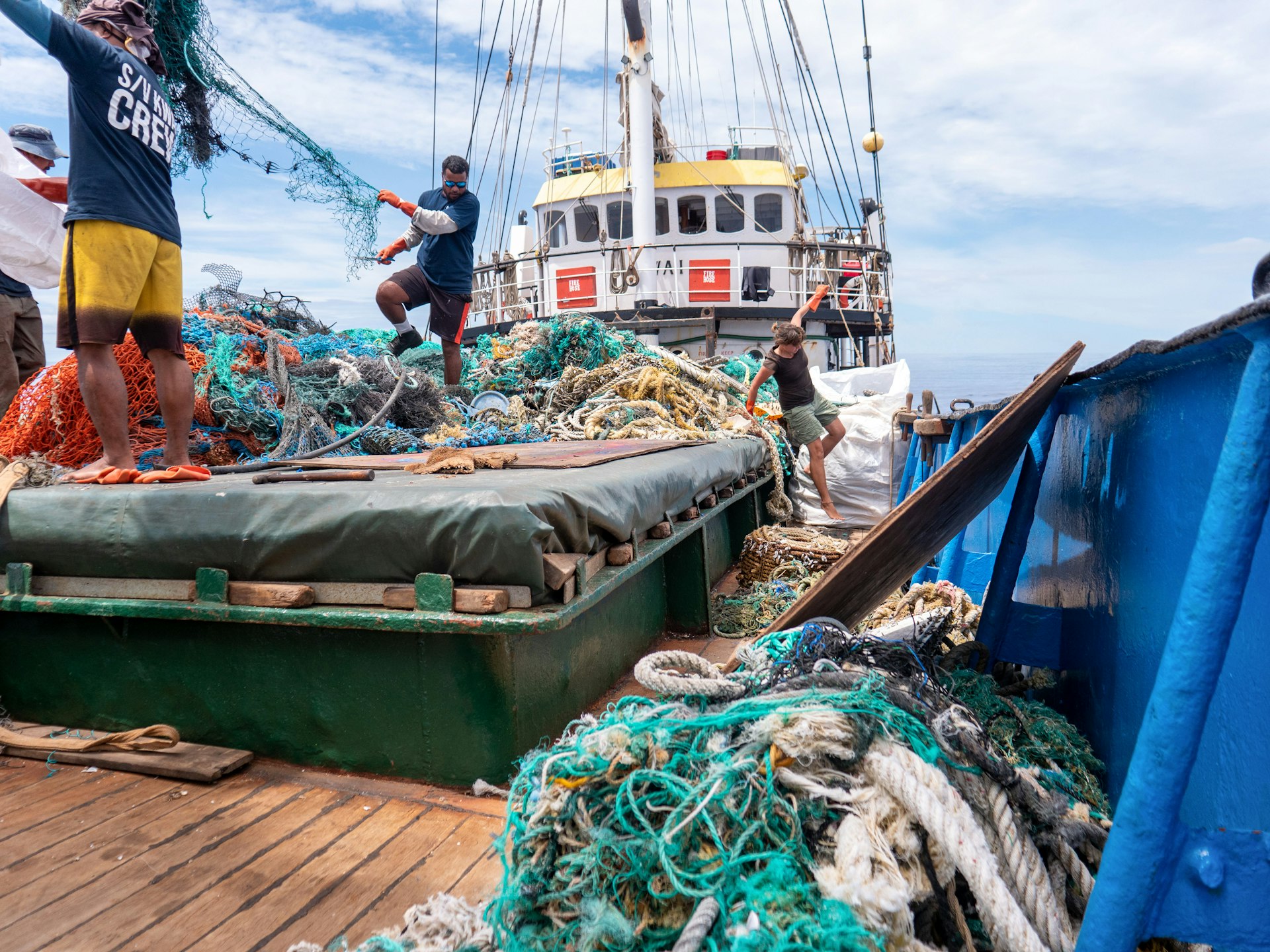 Ocean Voyages Institute crew examine plastic debris on deck