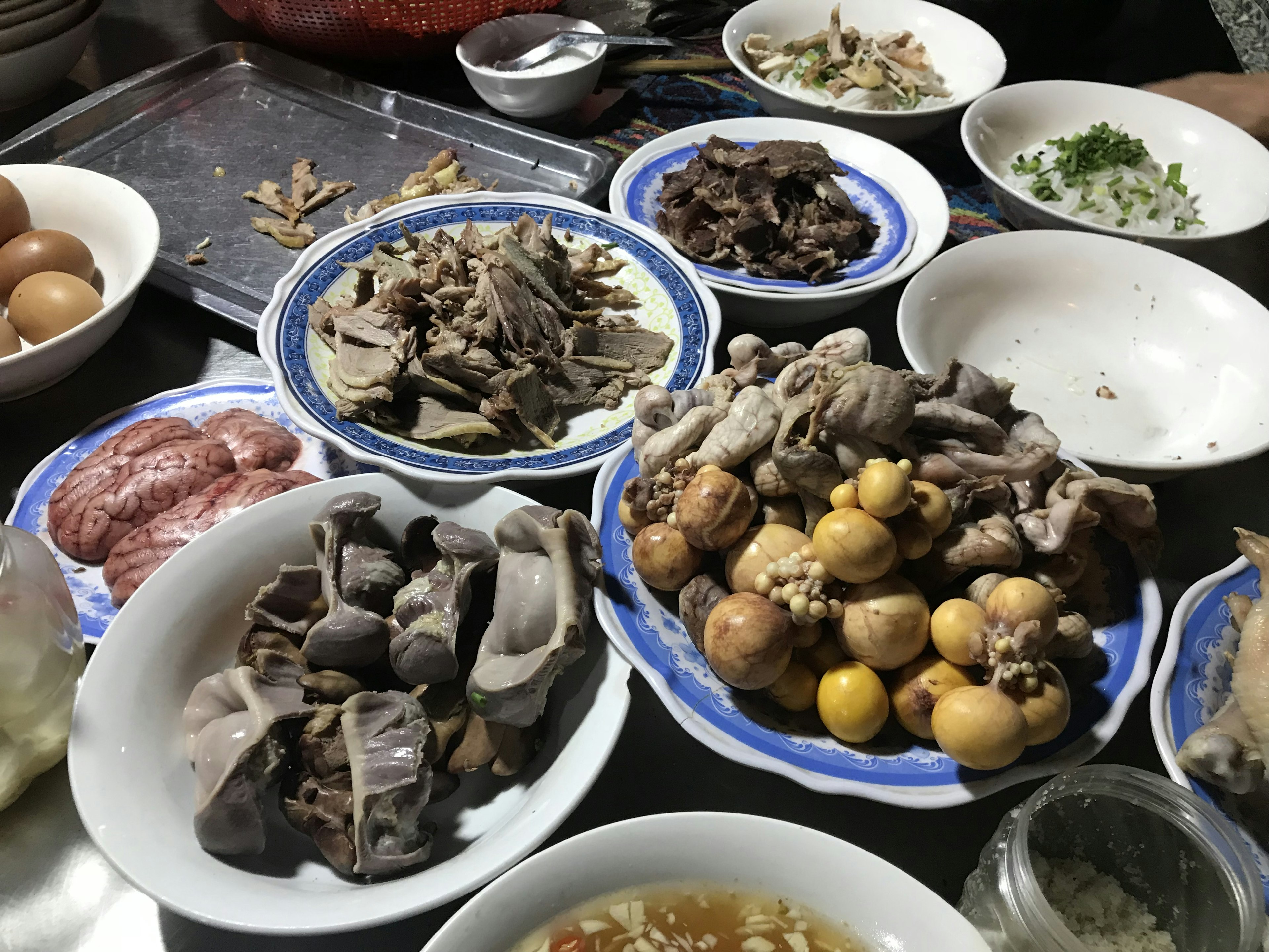 Brains and organs are among the dishes laid out on a soup street food stall