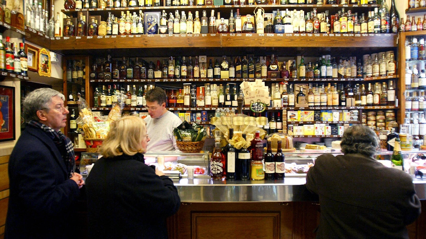 BARCELONA, Spain:  Customers enjoy the special food on offer at the Bodega Quimet and Quimet in the Poble Sec area of Barcelona, 20 December 2005. Quimet & Quimet turns out to be quite a special place, and far from a 'normal' tapas bar. Well over 90 percent of the products they serve come out of a can or a jar. Most people might not be enticed, but these are products from around the world found by many generations of men named "Quim" (the bar opened in 1914). Baby marinated artichokes, for example, still have crunch and anchovies are plump and delicious, not limp and salty. AFP PHOTO/CESAR RANGEL  (Photo credit should read CESAR RANGEL/AFP via Getty Images)