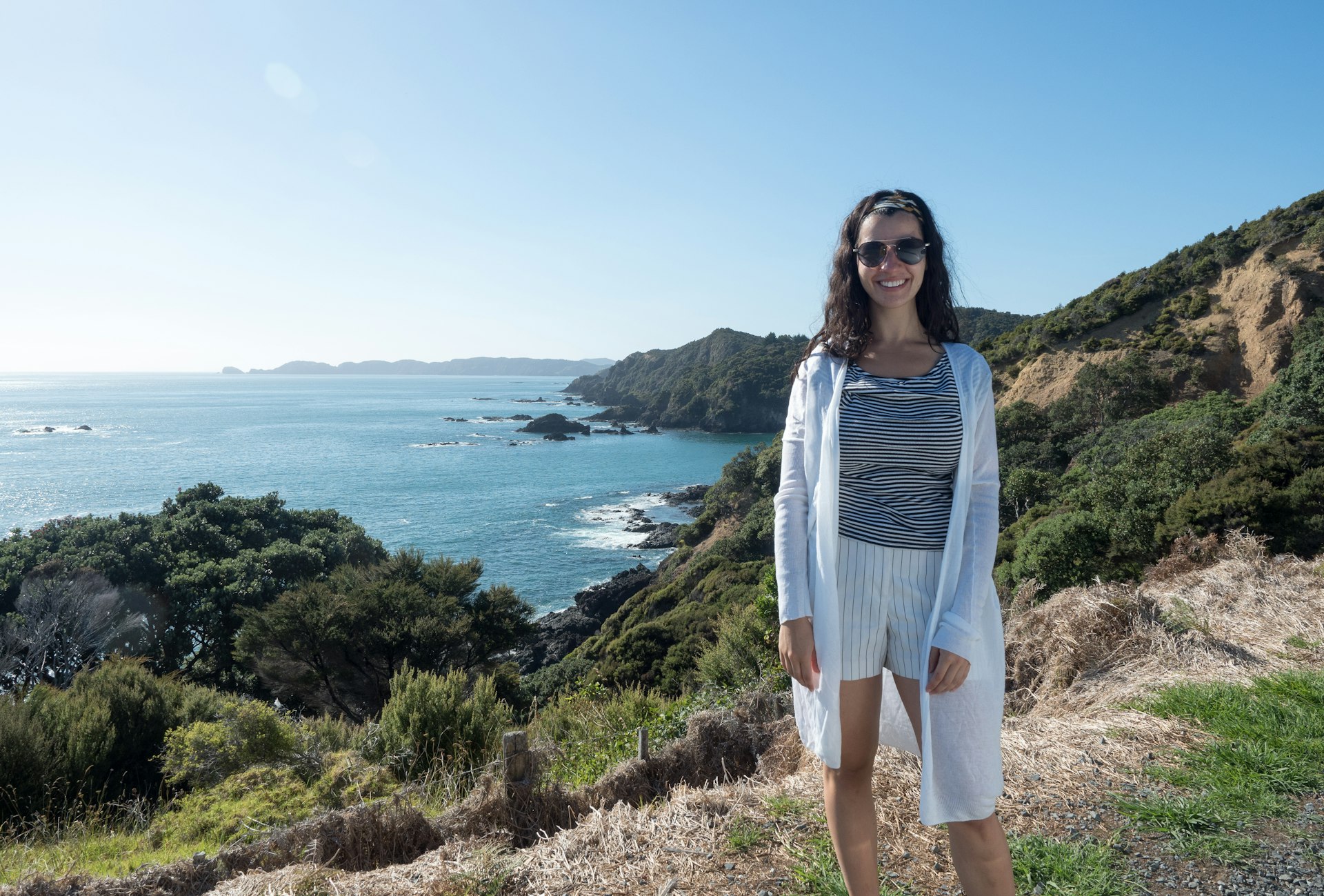 Caterina stands cliffside in Russell, North Island, New Zealand