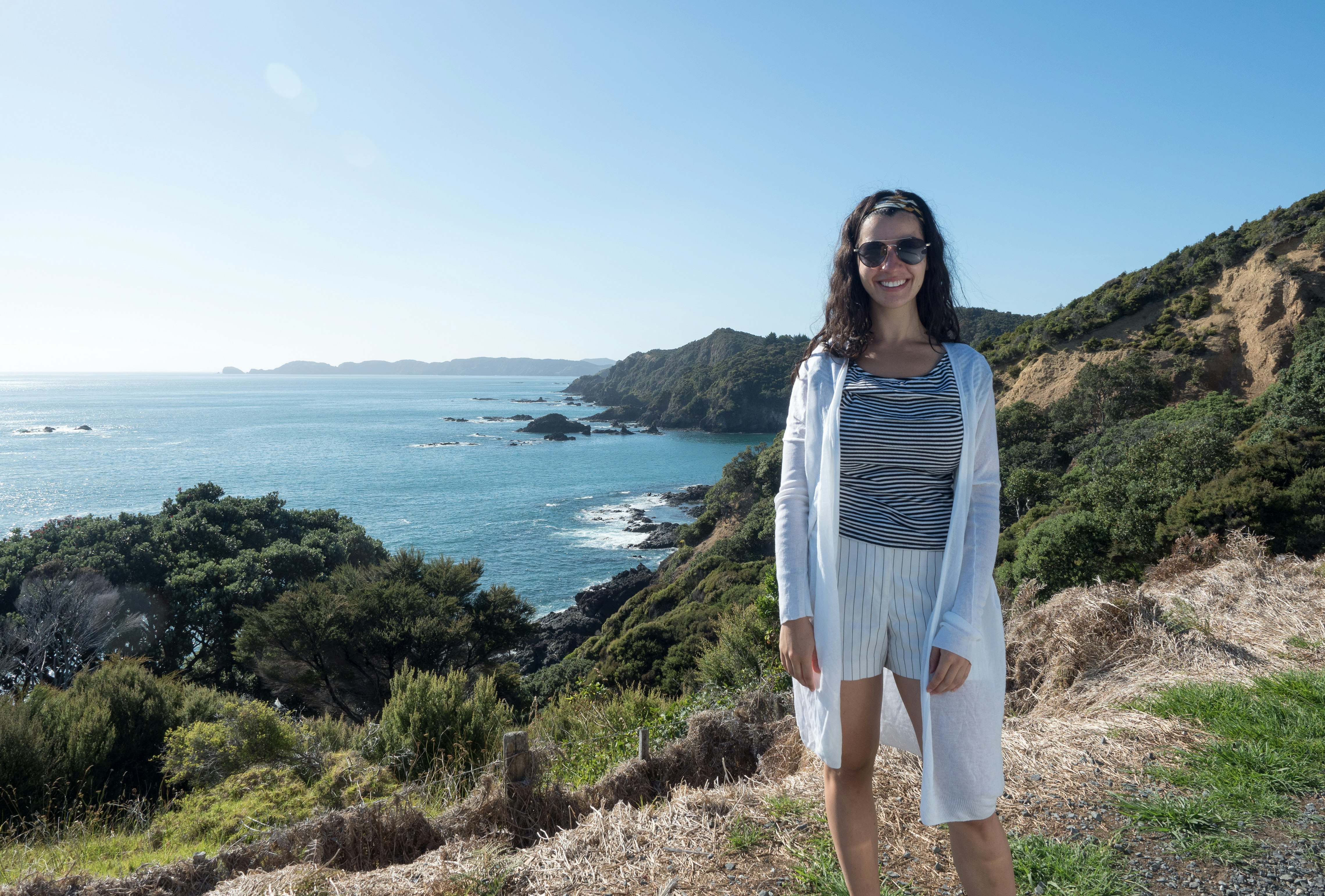 Caterina stands cliffside in Russell, North Island, New Zealand