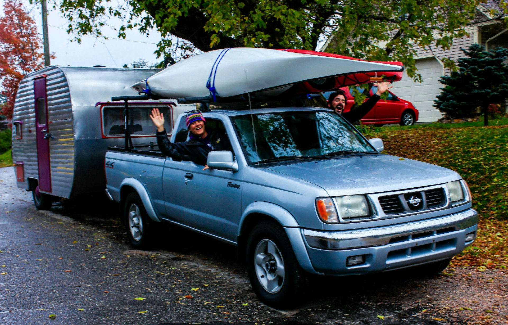 Shari and Hutch in their rig, including a canned ham trailer and pickup truck