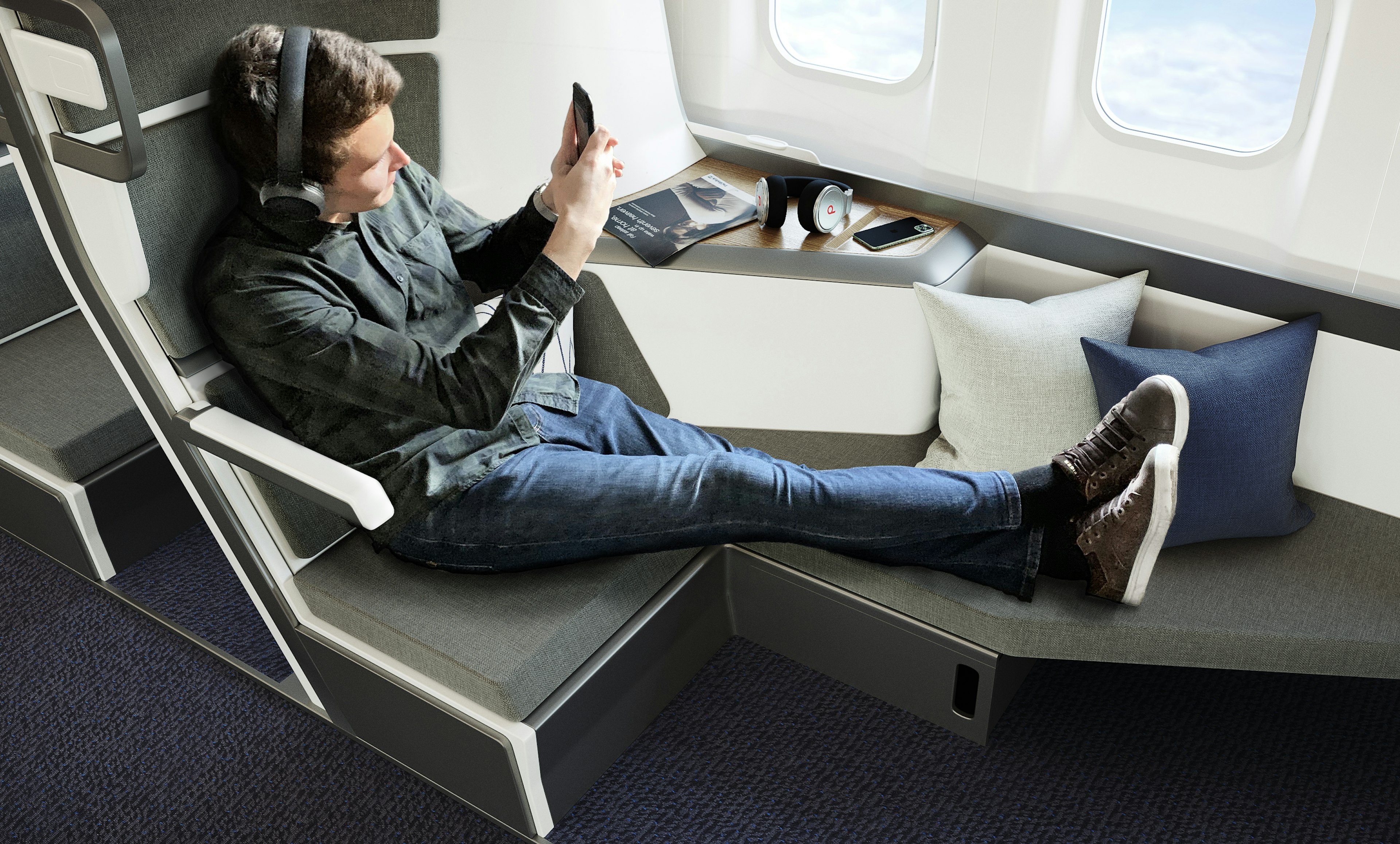 A man with headphones lounges on an airline lie-flat seat