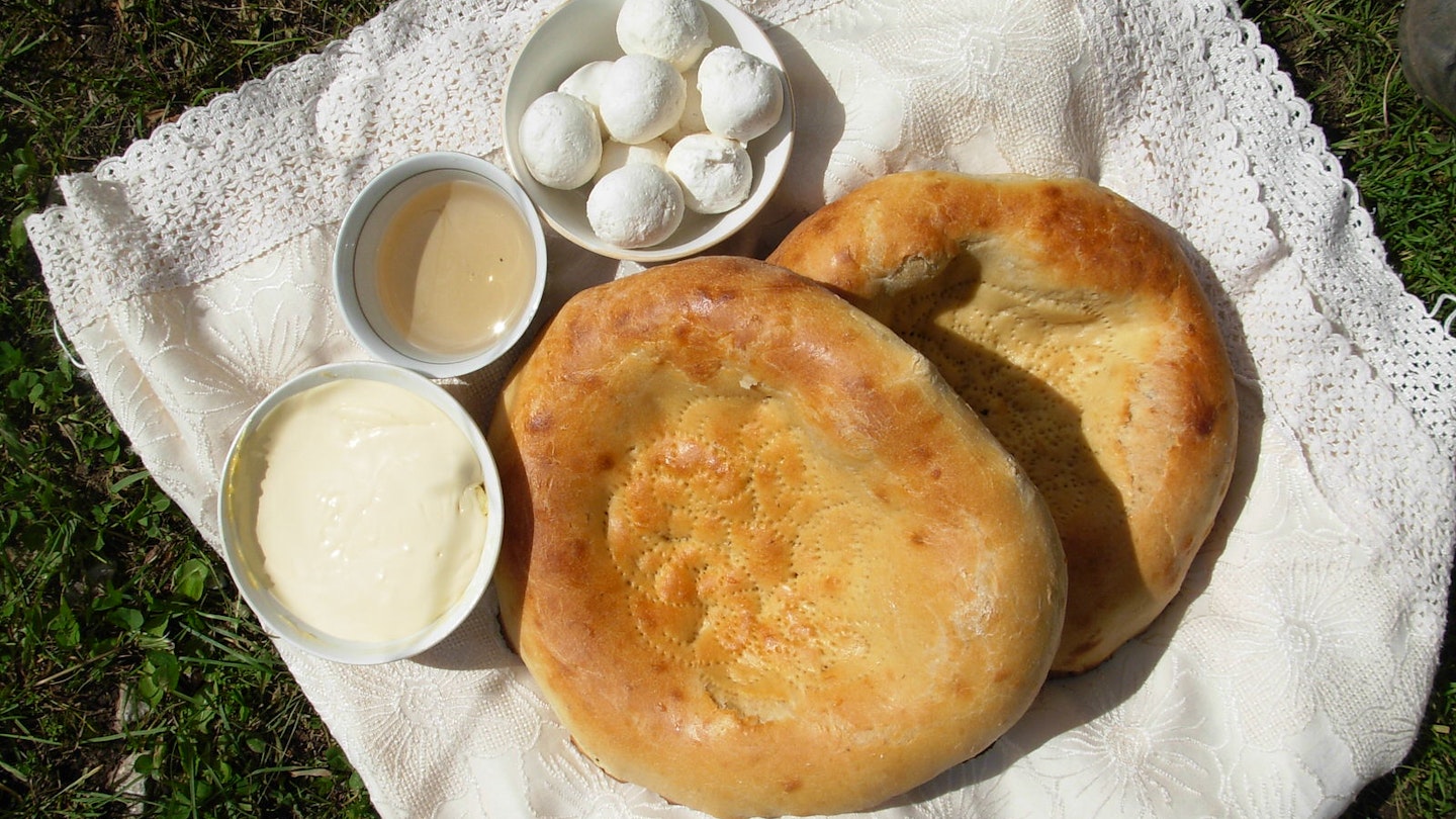 An impromtu trailside snack of non bread, kaimak (cream) and kurort (dried yoghurt balls), Murdash Valley, Alay Region