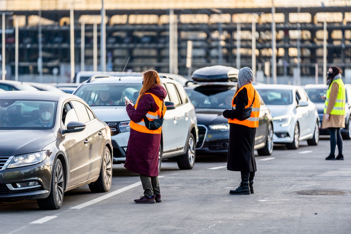 People checking cars in to the Vilnius Drive in Movie theatre