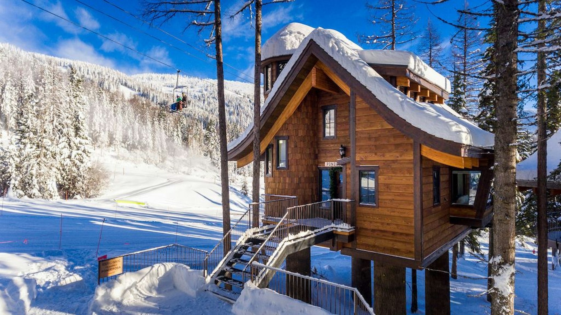 A treehouse cabin in the snow