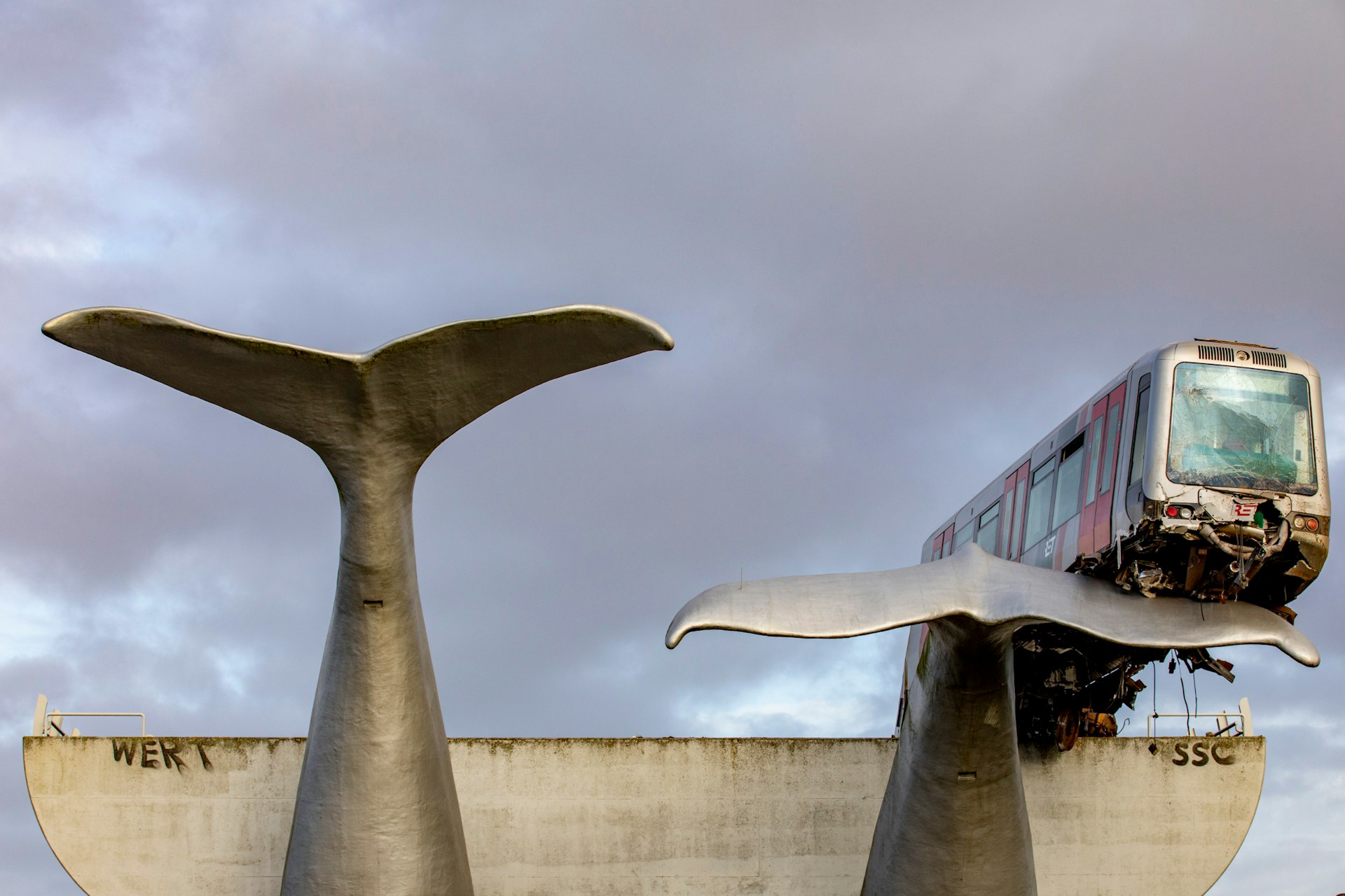 A train that landed on a whale tail sculpture in The Netherlands